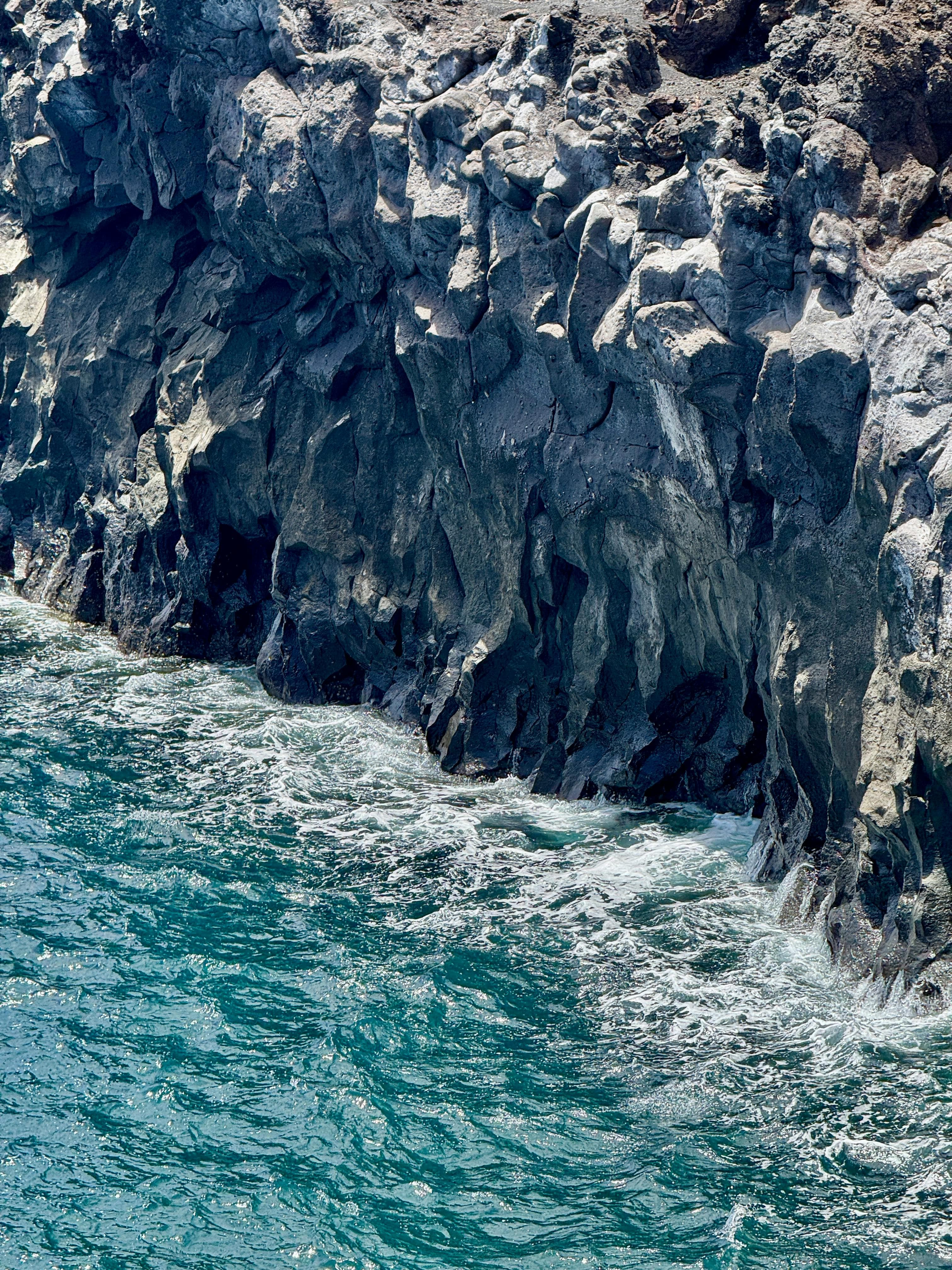 Rocky volcanic shore of Lanzarote with crystal clear Atlantic waters